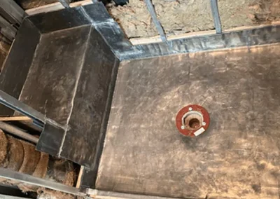 Shower pan and floor drain installation during bathroom renovation